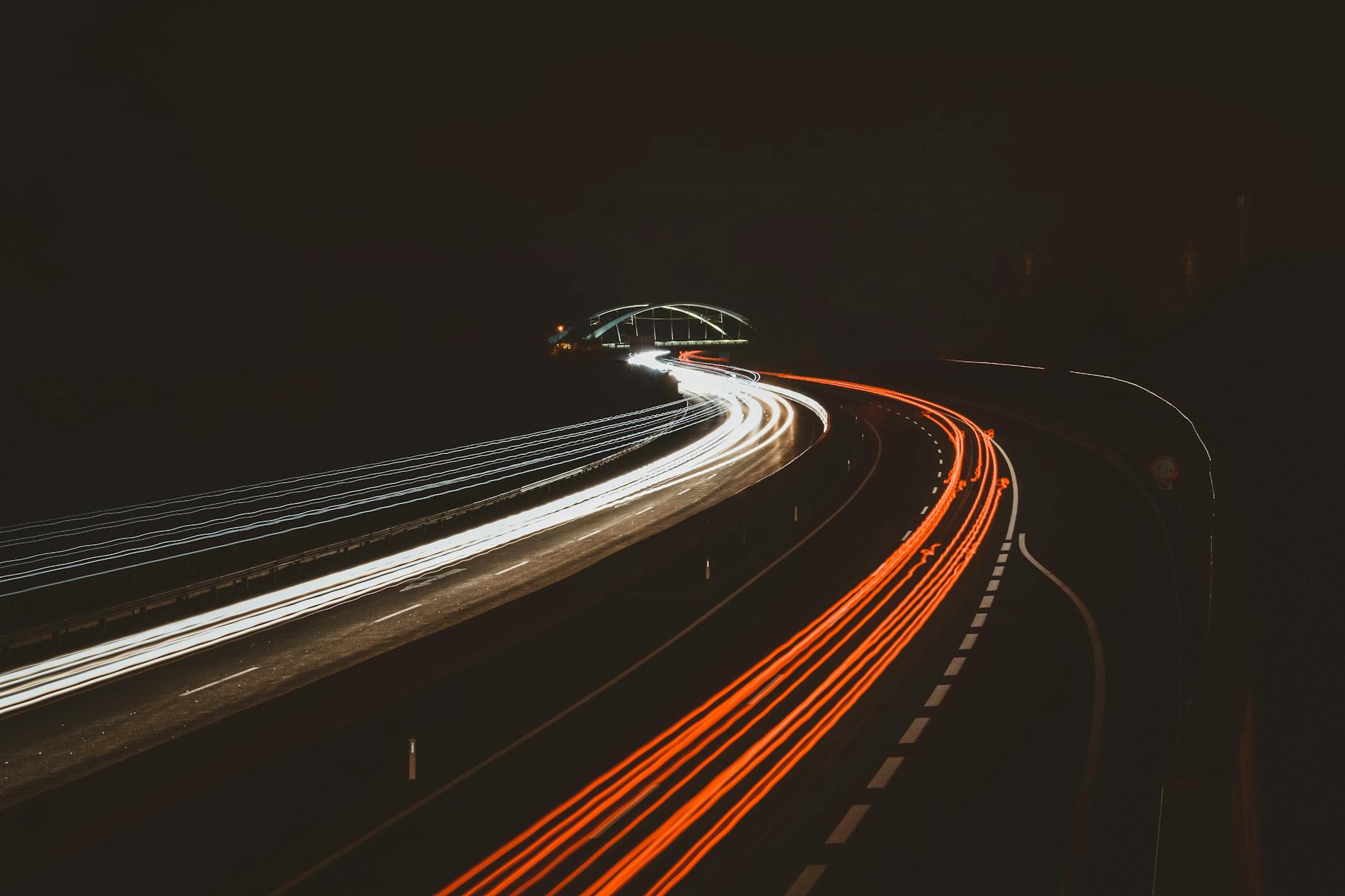 time lapse photography of vehicles on road during nightime