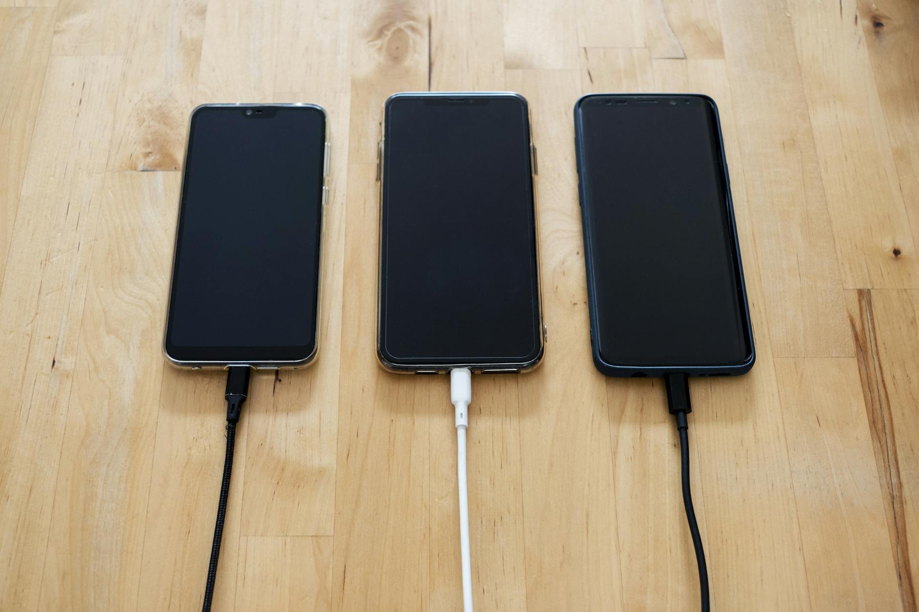 black android smartphones on brown wooden surface